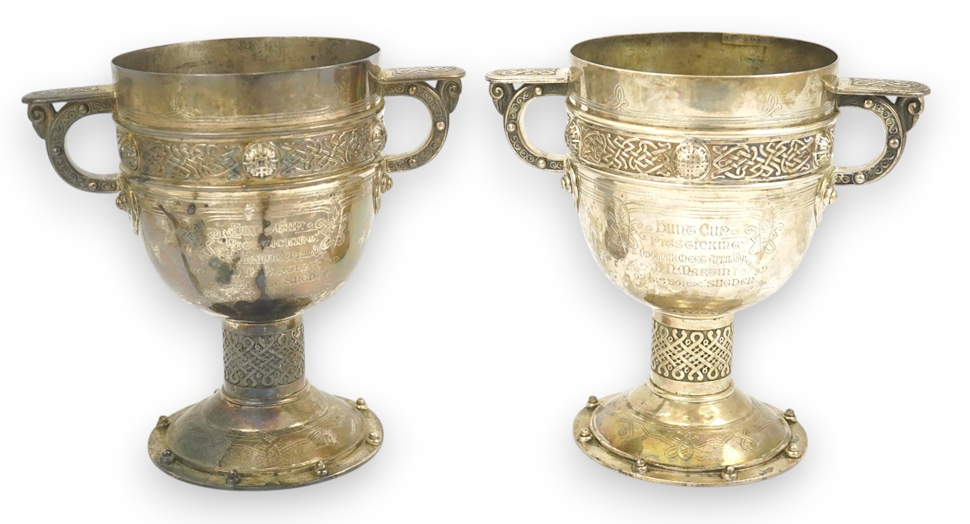 A pair of late Victorian Arts & Crafts Celtic style silver two handled presentation pedestal trophy cups, by Elkington & Co